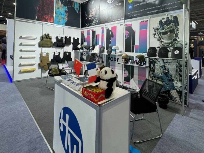 H Win's booth showcasing their range of bulletproof vests and tactical gear at a trade show