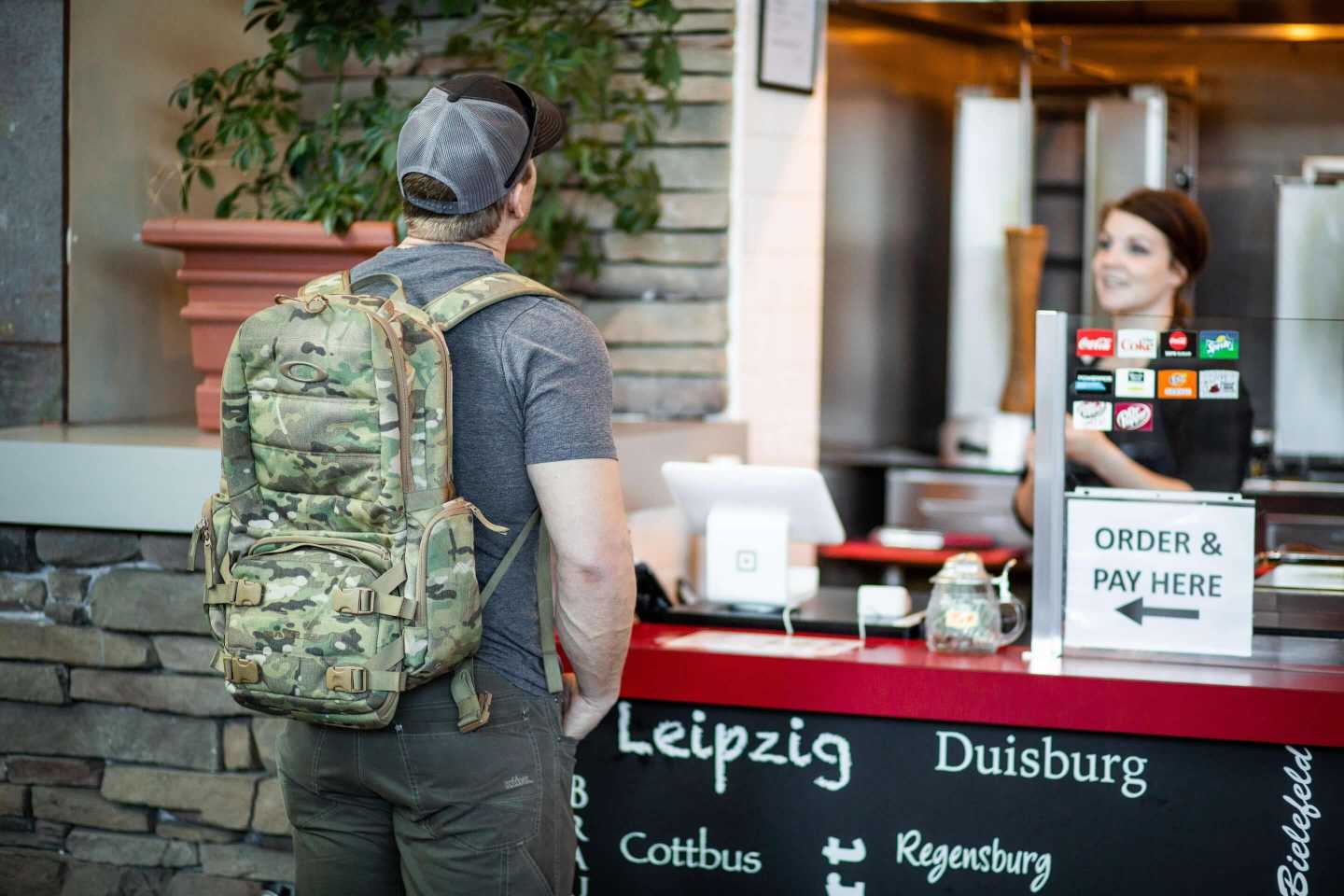 A man wearing a ballistic backpack in public